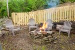 Side yard fire pit behind fenced pet area